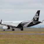 Air New Zealand white and black airplane on brown field during daytime