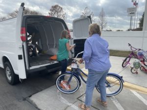 American Airlines Federal Credit Union team members help load donated bikes into a van in Dallas-Fort Worth.