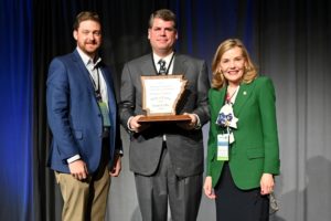 Louis Cella, center, poses with Travis Napper, Director of Arkansas Tourism