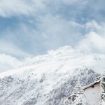 white and brown house and mountain covered snow