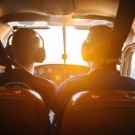 two men piloting plane during daytime