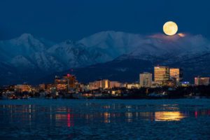A rising full moon over Anchorage