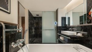 The bathroom features a separate rain shower and soaking tub