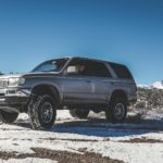 silver SUV on snow mountain