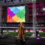 Clad in a possum-skin cloak, Murrundindi, head man of the Wurundjeri Clan of Melbourne, plays the didgeridoo at the AIME Opening Party at Marvel Stadium