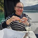 PTM Rose Febo enjoying the spectacular scenery of Queen Charlotte Sound/Tōtaranui, sampling local seafood matched with local wines on the Seafood Odyssea Cruise.