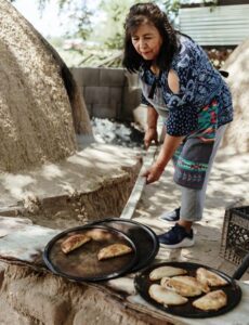 Observing how to make freshly baked Horno bread at the Naranjo Family's Puebloan Home (Courtesy of The Inn of The Five Graces)