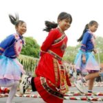 Photo taken on April 13, 2024, shows that three girls of Yanglin Village are dancing on the long bamboo poles. (Photo by Chen Qihai)