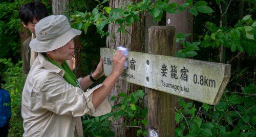Part of the trail maintenance involves cleaning up signage.