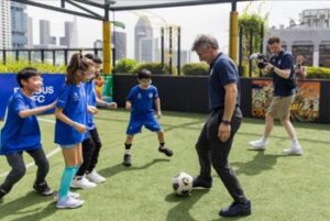 Chelsea Football Club legend Gianfranco Zola enjoying a friendly game with young beneficiaries from the Singapore Disability Sports Council on Saturday