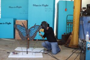 Artist, Alex Heveri works tirelessly to bring butterfly beauty to The Flower Fields.