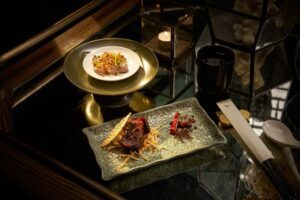 Free-range chicken with black truffle and coriander (黑松露芫荽涼拌走地雞) & braised wagyu beef with aged tangerine peel (陳⽪燴和⽜).