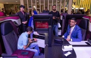 Qsuite curiosity takes off—passengers explore comfort before boarding begins.