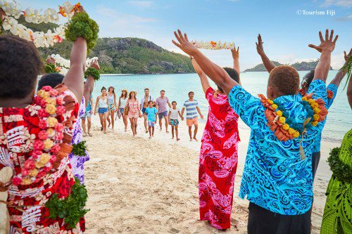 Island locals welcoming tourists on beach