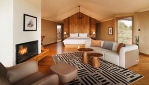 Inside Warangi Ridge—pangolin-inspired suite with fireplace, finesse, and savanna charm.