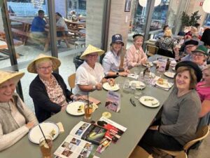 Helloworld Travel Alexandra Heights clients sporting their travel hats for an exciting round of Travel Trivia