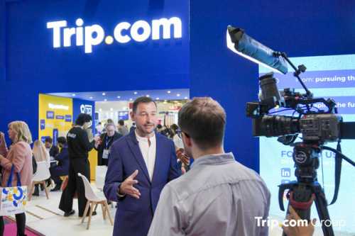 Mr Andy Washington, General Manager for Europe, is taking interviews at the Trip.com Group booth