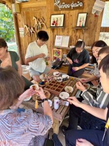 Tourists helping to make local village (OTOP) products. A very hands on experience.