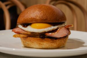SRG_HarbourWatch_Bacon & Egg Roll, Brioche Bun, Black Forrest Bacon, Fried Egg, House BBQ Sauce_Credit_ Zi Chen
