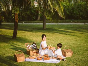 Mom and kid are enjoying picnic in the garden (PRNewsfoto/Radisson Blu Resort, Phu Quoc)