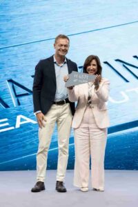 Director of Monfalcone Shipyard Cristiano Bazzra with Carnival Cruise Line President Chritine Duffy hold first piece of steel to celebrate start of construction