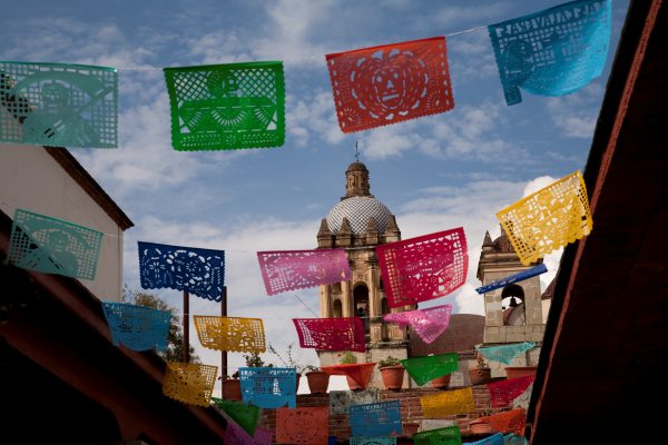 colorful tissue flags fly near cathedral - 97543454