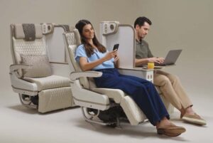 Emirates' new electric Premium Economy seat featuring integrated phone holder