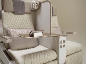 Emirates' new electric Premium Economy seat featuring integrated phone holder