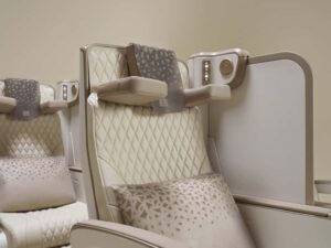 Emirates' new electric Premium Economy seat featuring integrated phone holder