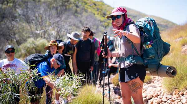 Meg Mussehl, World Expeditions guide, shares insights with the group on the Larapinta Trail. Please credit Bradley Pittman, Photographer