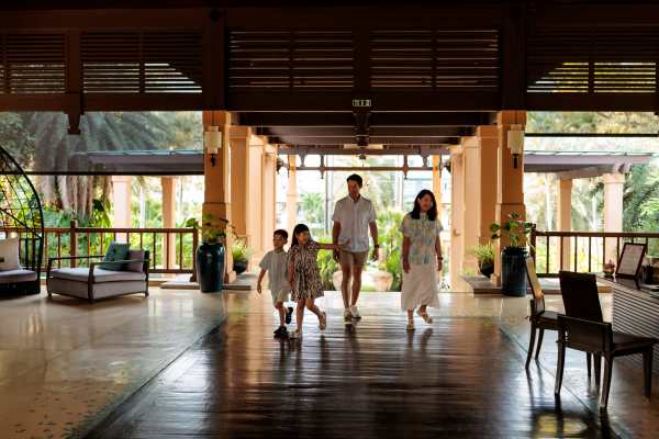 Happy family checking in at hotel